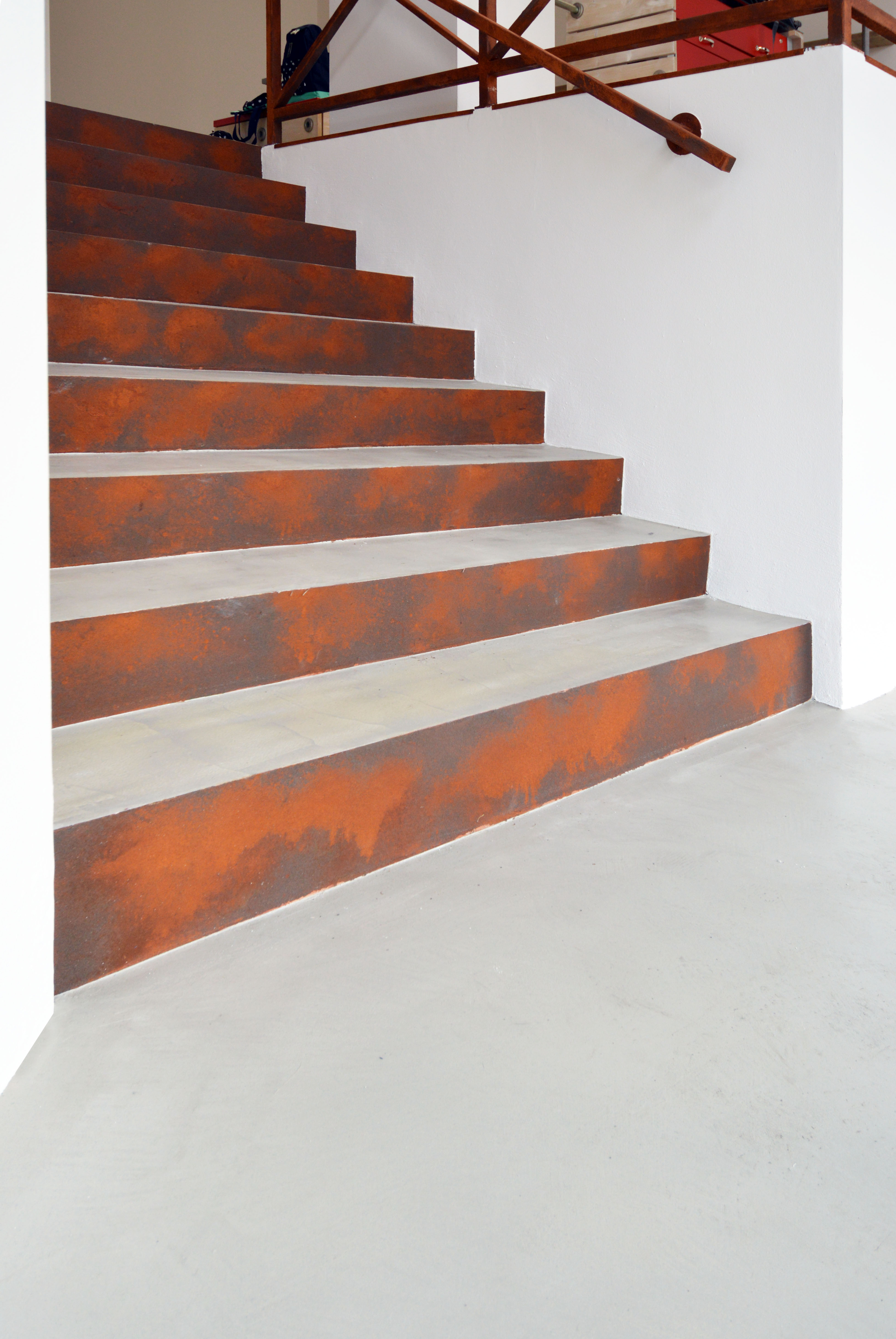 Microverlay®, low thickness concrete resin coating with taupe and Oxyrust® finish, vertical Corten effect coating. Marco stationery. Rovereto (TN). Project: Studio A22